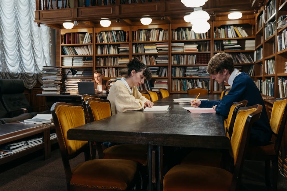 Group of students diligently studying in a traditional library filled with books, tables, and dim lighting